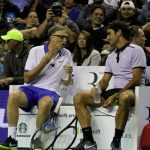 Bill Gates (left) converse with Roger Federer (right) during the match